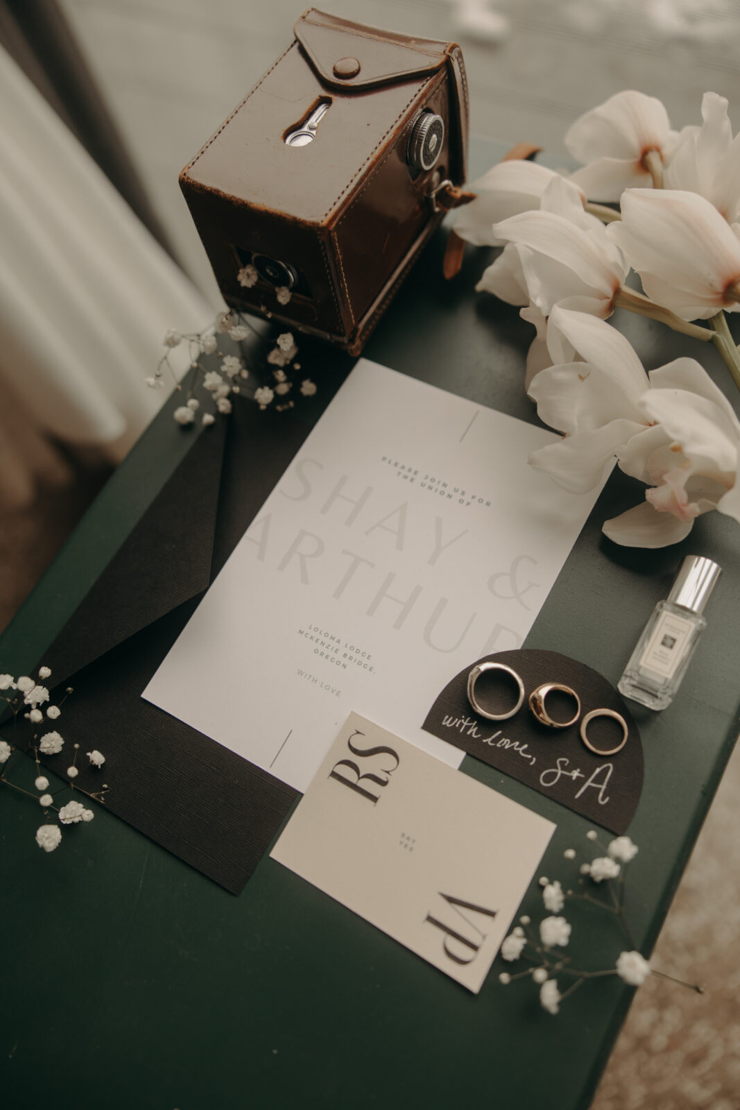 Elopement invitation, wedding rings, flowers, and details