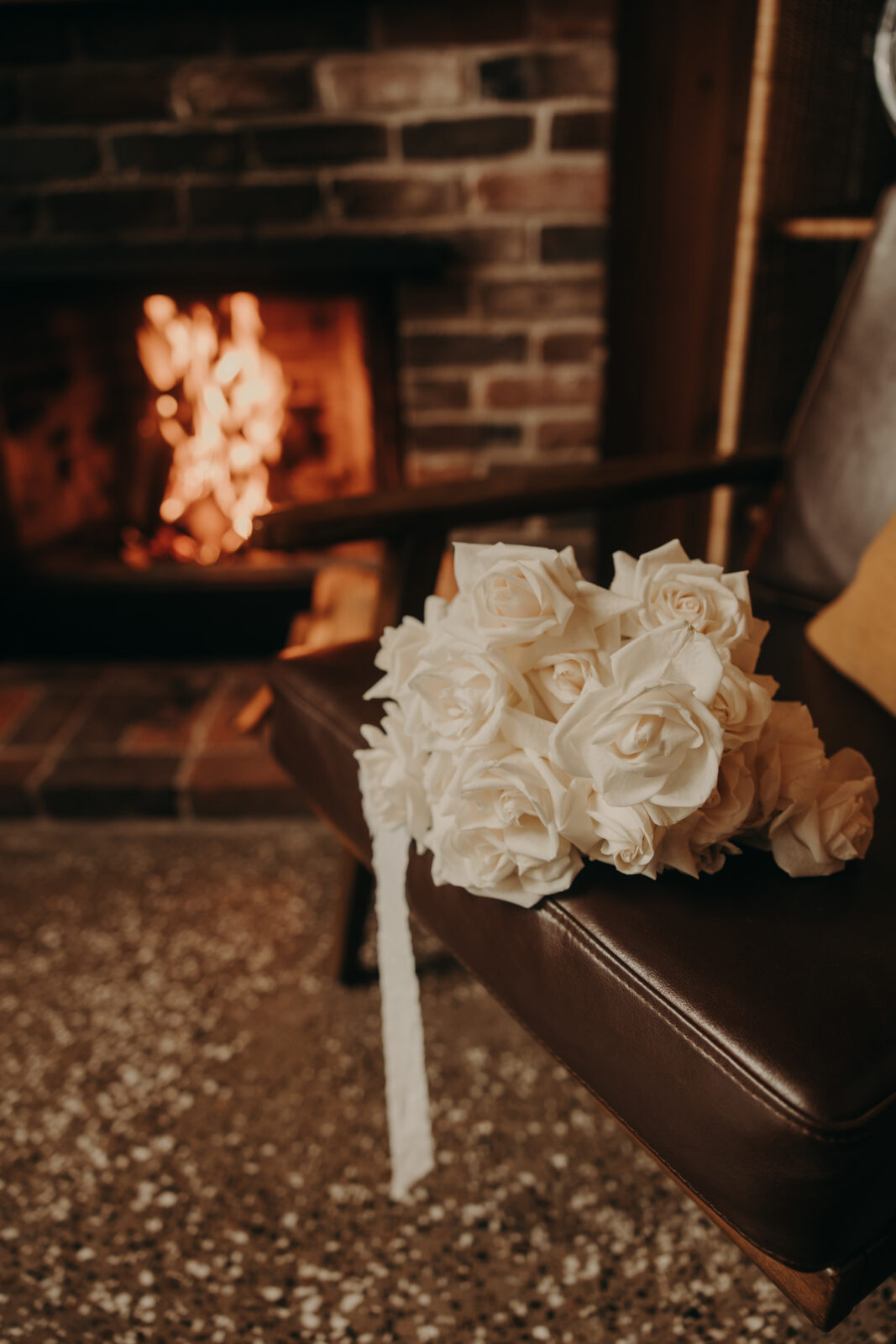 cabin elopement flowers with fireplace in the background
